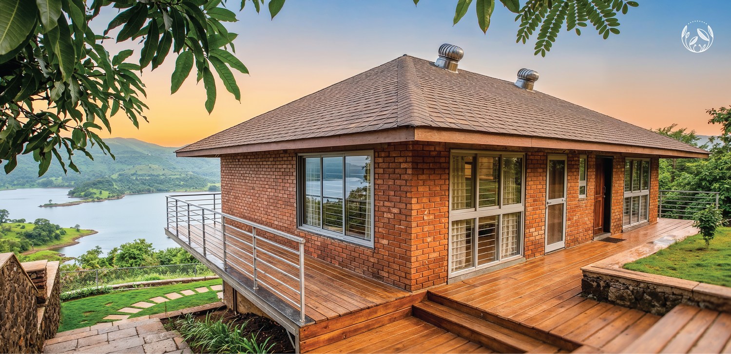Brick architecture and an open deck facing the Bhatghar Backwater.
